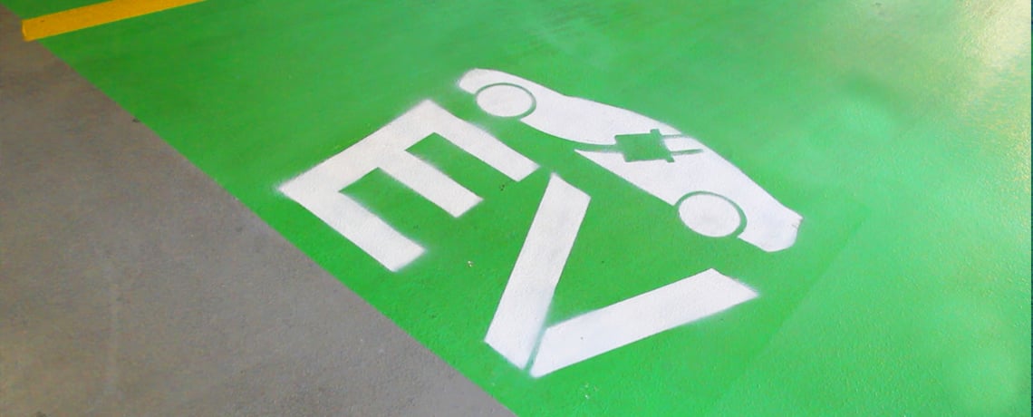 Electric vehicle owners plug into charging at work